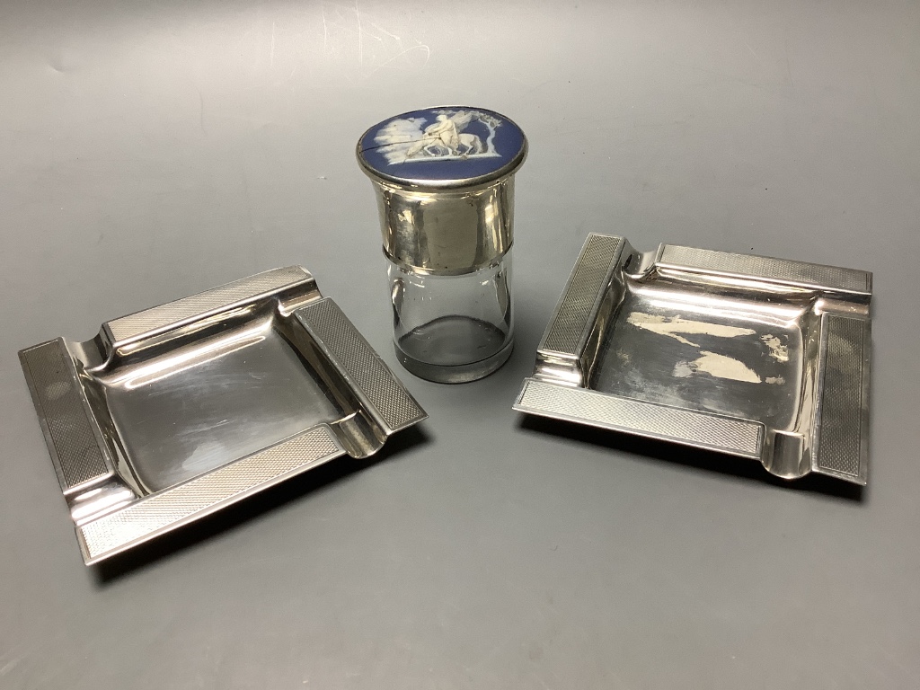 A pair of modern part engine turned silver ashtrays, 95 mm, 176 g and a silver and Wedgwood plaque mounted salt glass salts bottle, a.f.